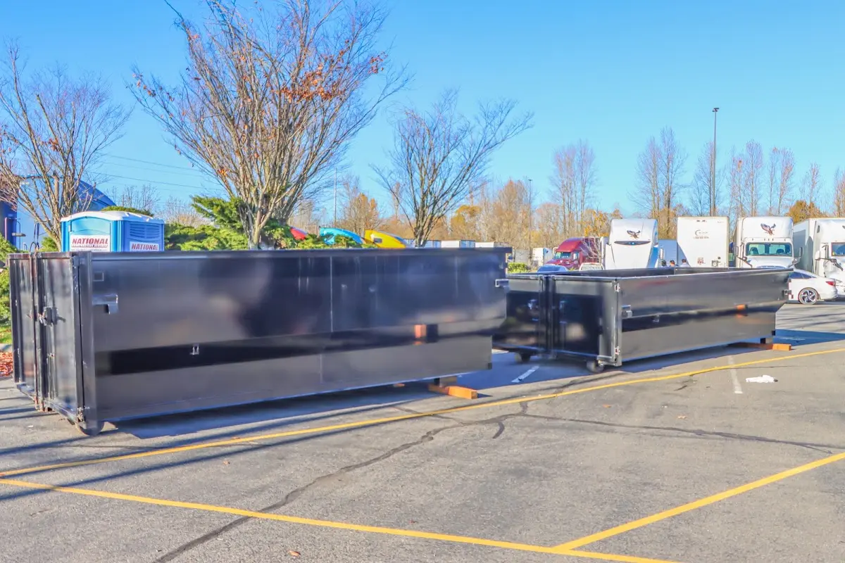 Professional dumpster rental service with roll-off container on residential driveway in Rolesville